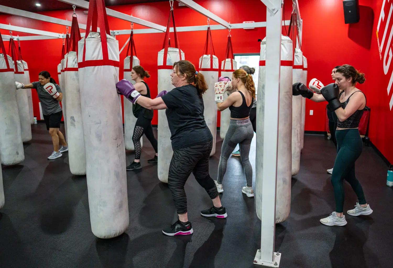 Members training on heavy bags in a PUNCH cardio boxing class